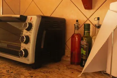 a microwave on a counter next to two bottles of wine at Samara Beach Las Palmeras Condo with Ocean view in Sámara
