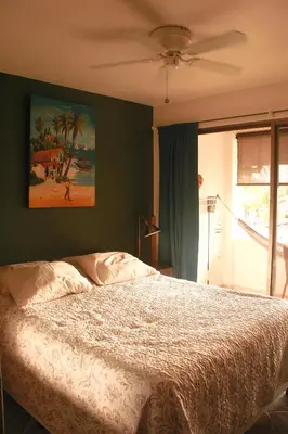 a bedroom with a bed and a painting on the wall at Samara Beach Las Palmeras Condo with Ocean view in Sámara