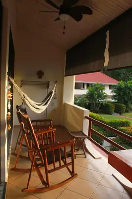 a hammock and a chair on a porch at Samara Beach Las Palmeras Condo with Ocean view in Sámara
