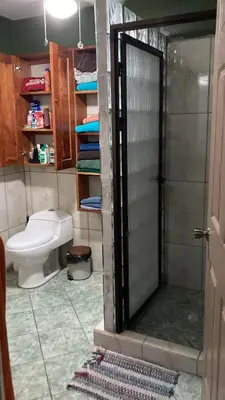 a bathroom with a toilet and a shower with a shower at Samara Beach Las Palmeras Condo with Ocean view in Sámara