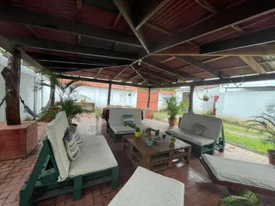 an outdoor patio with couches and a table at Hospedaje Casa Mar in Liberia