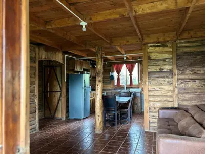 a living room with a couch and a table in a cabin at La Cabaña de Tuto Estate Coffees in San Pablo