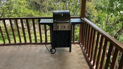 a grill sitting on a deck with a grill at La Cabaña de Tuto Estate Coffees in San Pablo