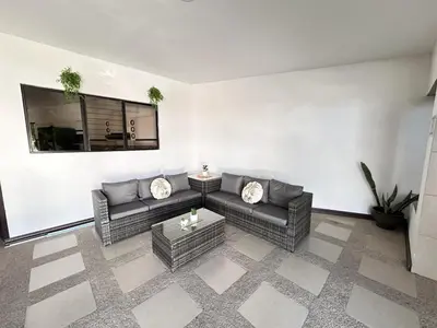 a living room with a couch and a table at Hotel Boutique CasAguacate close to Airport, Pedregal, Centro de Convenciones de Costa Rica in Potrerillos