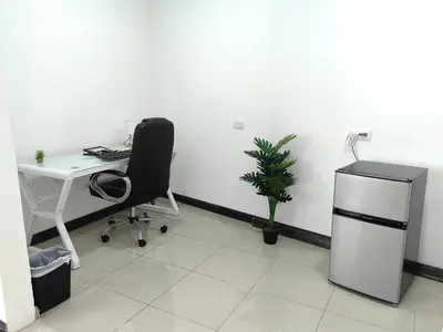 an office with a desk and a chair and a plant at Hotel Boutique CasAguacate close to Airport, Pedregal, Centro de Convenciones de Costa Rica in Potrerillos