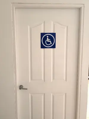 a white door with a sign on it at Hotel Boutique CasAguacate close to Airport, Pedregal, Centro de Convenciones de Costa Rica in Potrerillos