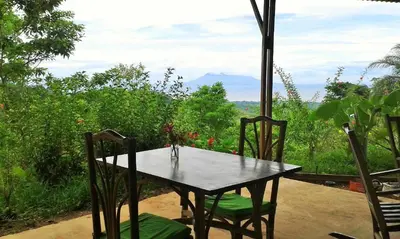a table and chairs with a view of a mountain at Tierra Madre Eco Lodge in Los Andes