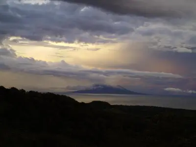 a stormy sky with a mountain in the water at Tierra Madre Eco Lodge in Los Andes