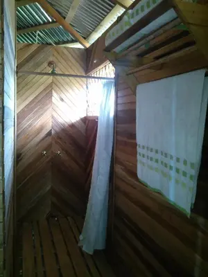a sauna with wooden walls and a curtain at Tierra Madre Eco Lodge in Los Andes