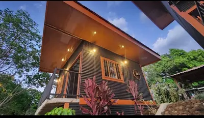 a small house with a large window on the side of it at Fruta mango # 3 in Playa Guacalillo