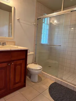 a bathroom with a toilet and a shower and a sink at Refugio de paz in Jacó