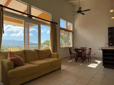 a living room with a couch and a table at Refugio de paz in Jacó