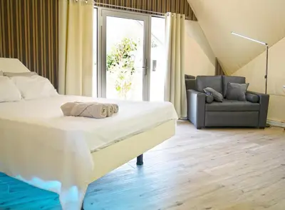 a bedroom with a bed and a chair and a window at Pacific Glamp in Potrero