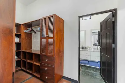 a bathroom with a mirror and a wooden closet at Casa Buena Vista with Incredible Ocean Views in Playa Hermosa