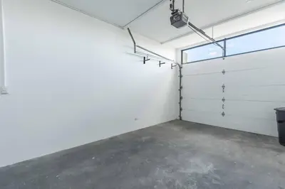 an empty garage with white walls and a window at Casa Buena Vista with Incredible Ocean Views in Playa Hermosa