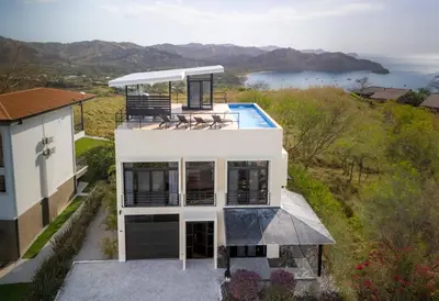 an aerial view of a house with a swimming pool at Casa Buena Vista with Incredible Ocean Views in Playa Hermosa