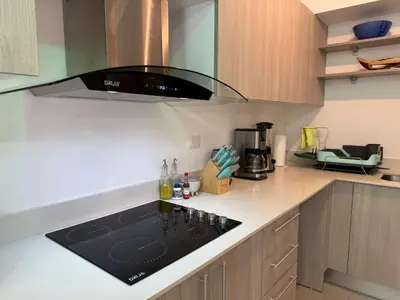 a kitchen with a counter top with a microwave at Punta Esmeralda Paradise in Tarcoles