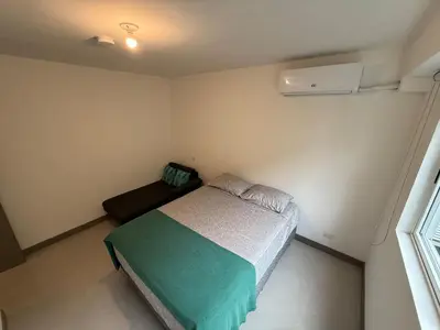 a small bedroom with a bed and a window at Punta Esmeralda Paradise in Tarcoles