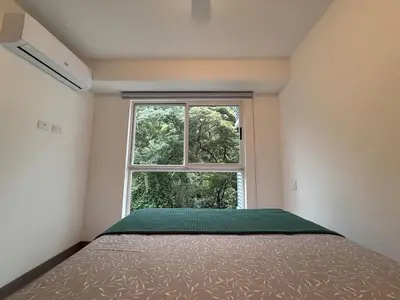 a bedroom with a bed and a window at Punta Esmeralda Paradise in Tarcoles