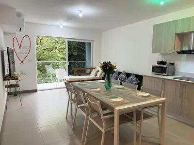 a kitchen and dining room with a table and chairs at Punta Esmeralda Paradise in Tarcoles