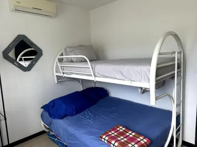 a small room with two bunk beds and a mattress at Herradura casa vacacional in Herradura