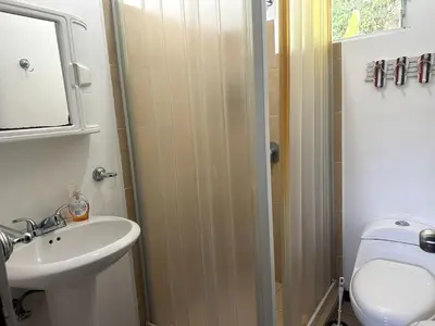 a bathroom with a sink and a toilet and a shower at Herradura casa vacacional in Herradura