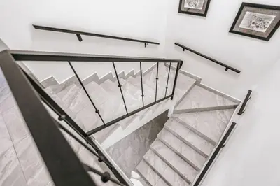 a staircase with a glass railing in a building at Casa Sol in Punta Leona