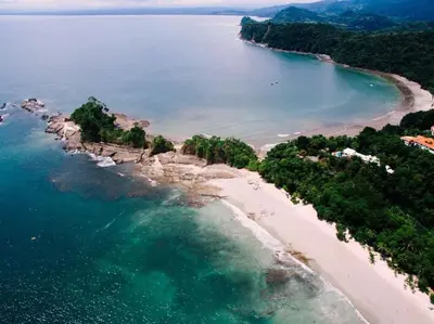 an aerial view of a beach with trees and water at Casa Sol in Punta Leona