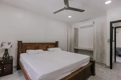 a bedroom with a bed and a ceiling fan at Casa Sol in Punta Leona