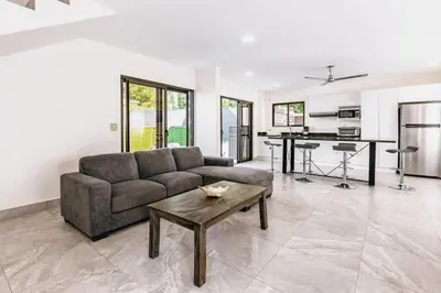 a living room with a couch and a table at Casa Sol in Punta Leona