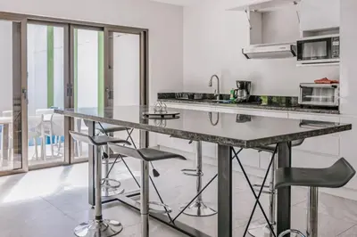 a kitchen with a large counter with stools in it at Casa Luna in Punta Leona