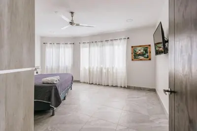a bedroom with a bed and a window at Casa Luna in Punta Leona