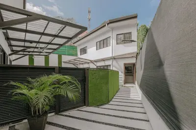 a hallway of a building with stairs and plants at Casa Luna in Punta Leona