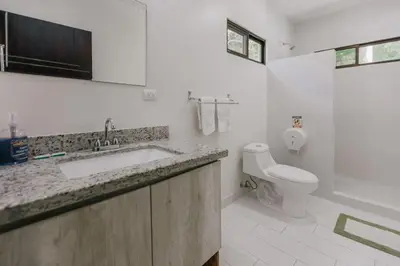 a bathroom with a sink and a toilet at Casa Luna in Punta Leona
