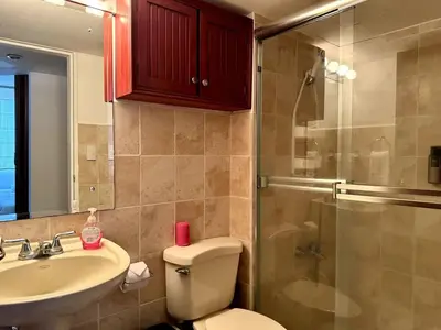 a bathroom with a toilet and a sink and a shower at . 5 min Walking Beach Jaco Apartment in Jacó