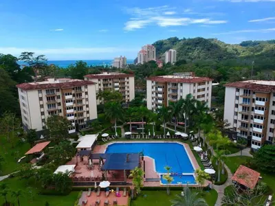 an aerial view of apartment buildings and a swimming pool at . 5 min Walking Beach Jaco Apartment in Jacó