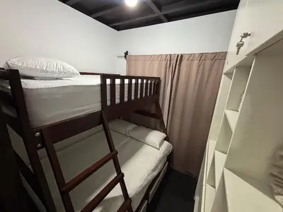 a bedroom with a bunk bed and a closet at Casa Arenas in Herradura