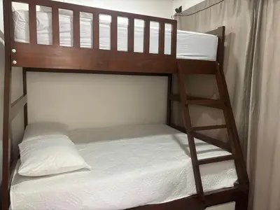 a bunk bed with a ladder next to a bunk bed at Casa Arenas in Herradura