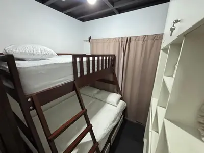 a bedroom with a bunk bed and a closet at Casa Arenas in Herradura