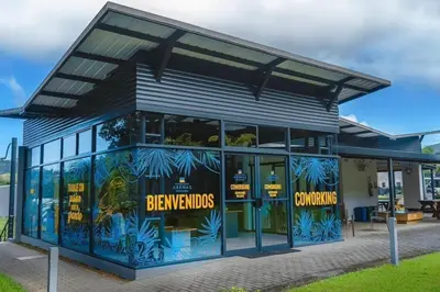 a building with blue and yellow signs on it at Casa Arenas in Herradura