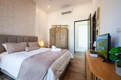 a bedroom with a large bed and a desk at .Lujosa casa en Hacienda Pinilla in Tamarindo