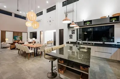 a kitchen and dining room with a dining table at .Lujosa casa en Hacienda Pinilla in Tamarindo