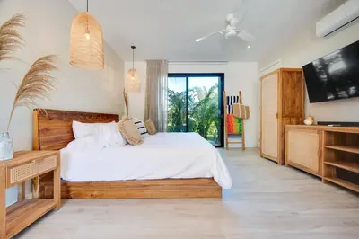 a bedroom with a large bed and a tv at The Bungalows #4 - Boutique Hotel in Flamingo Beach - Top Level Studio in Playa Flamingo