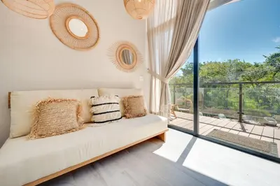 a living room with a couch and a balcony at The Bungalows #4 - Boutique Hotel in Flamingo Beach - Top Level Studio in Playa Flamingo