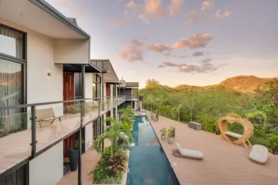 a house with a swimming pool on a balcony at The Bungalows #4 - Boutique Hotel in Flamingo Beach - Top Level Studio in Playa Flamingo
