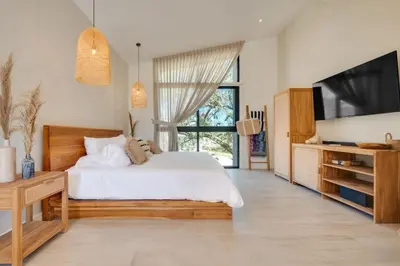 a bedroom with a white bed and a television at The Bungalows #5 - Boutique Hotel in Flamingo Beach - Ground Level Studio in Playa Flamingo