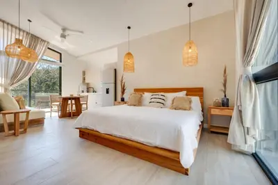 a bedroom with a large bed and a kitchen at The Bungalows #5 - Boutique Hotel in Flamingo Beach - Ground Level Studio in Playa Flamingo