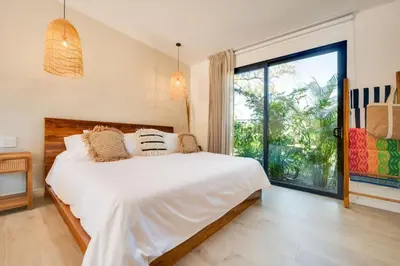 a bedroom with a white bed and a large window at The Bungalows #3 - Boutique Hotel in Flamingo Beach - Ground Level Studio in Playa Flamingo