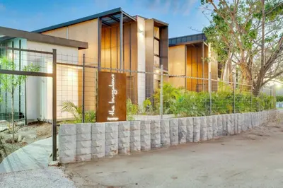 a house with a retaining wall and a fence at The Bungalows #3 - Boutique Hotel in Flamingo Beach - Ground Level Studio in Playa Flamingo