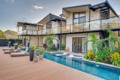 an exterior view of a house with a swimming pool at The Bungalows #3 - Boutique Hotel in Flamingo Beach - Ground Level Studio in Playa Flamingo